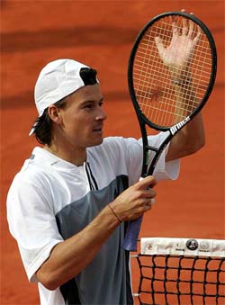 Guillermo Coria of Argentina reacts after winning his match against Mario Ancic of Croatia