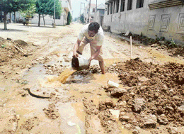 An MC worker repairs a manhole damaged by vehicles in the Model Town Extension area in Ludhiana.