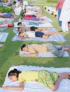 Children doing relaxation exercises as part of a yoga camp organised by the Bharatiya Yog Sansthan in Sector 44