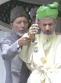 A priest displays the holy relic of Hazrat Sheikh Abdul Qadir Jeelani on the eve of Urs at his shrine in Khanyar, Srinagar, on Monday.