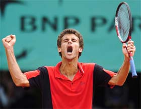 Gustavo Kuerten of Brazil reacts after defeating Feliciano Lopez of Spain during their fourth round match at the French Open at the Roland Garros stadium 