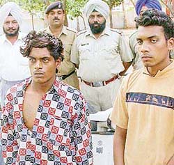 Sanjay, who was illegally carrying a countrymade pistol, and Anil Kumar, who was caught while riding a stolen scooter, in police custody in Chandigarh