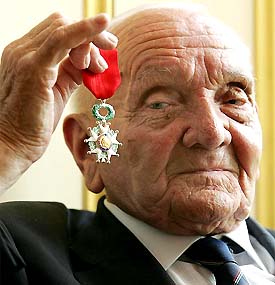 British D-Day veteran Jock Wilson receives a Legion D'Honneur medal at the French Ambassador's residence in London on Wednesday