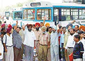 The CTU Workers Joint Action Committee holds �chakka jam� at the Sector 17 ISBT in support of their demands in Chandigarh
