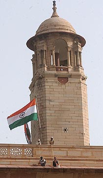 Labourers undertake repair work on the roof of the South Block building in New Delhi