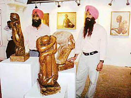 Artists Jaswinder Singh and Daljit Singh with their creations at an exhibition of paintings, sculptures and pencil sketches, organised by the North Zone Cultural Centre at Banasar Art Gallery in Patiala on Thursday.