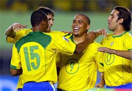 Brazil's Ronaldo (9) celebrates with team-mates Julio Baptista (15), Edmilson and Edu (17) after scoring his third goal against Argentina in the second half of their World Cup qualifying match in Belo Horizonte, some 400 km west of Rio de Janeiro, on Wednesday.  Brazil beat Argentina 3-1.  