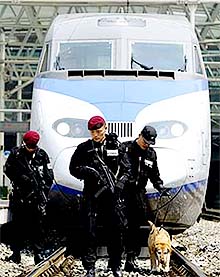 Members of South Korean Special Weapons and Tactics team checks a bullet train at the Seoul train station on Thursday