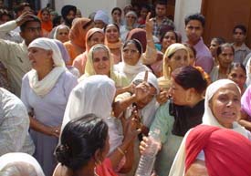Women mourn the death of Roopinder Kaur in front of her house at Bhagwan Nagar in Ludhiana