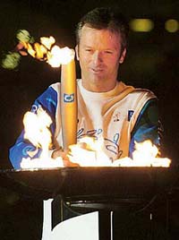 Australian of the Year and former cricket captain Steve Waugh lights a cylinder that ignites the Sydney 200 Olympic Games cauldron at Homebush Bay