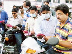 Members of the Ludhiana Seva Sangh distribute pamphlets that warn against the pollution on the occasion of the World Environment Day