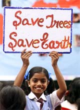 A schoolgirl holds a placard during Eco Watch, an awareness campaign to mark World Environment Day, in Bangalore