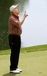 Jack Nicklaus points to the sky on the 12th hole after the ball hit the flagstick, bounced in and out of the hole and settled on the fringe of the green during the second round of the Memorial Tournament at Muirfield Village Golf Club in Dublin