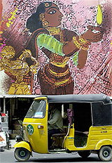 An auto-rickshaw driver rides past a promotional hoarding for a silk manufacturer in Chennai
