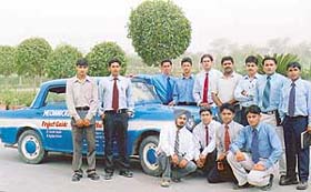 Engineering students pose with the environment-friendly low-cost "hybrid car" developed by them