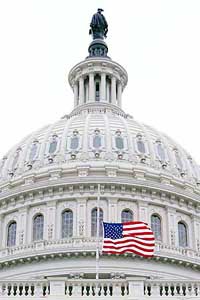 The US flag is lowered at half-mast at the US Capitol in Washington a few hours after the announcement of the death of former President Ronald Reagan