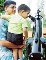Rushil shows his younger brother Itish how to reach out to stars above, in Chandigarh on Monday.