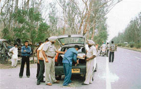 Policemen check vehicles as part of a drive launched