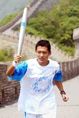 Chinese soccer player Yang Chen carries the Olympic Flame on the Great Wall near Beijing during a photo call promoting the Beijing leg of the global relay of the Olympic Flame