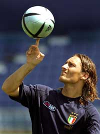 Italian striker Francesco Totti spins the ball during the team�s first training session in Lisbon
