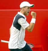 Slovakia's Karol Beck celebrates beating Britain's Tim Henman in their second round match at the Stella Artois Tennis Championships