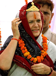 Ms Sonia Gandhi wears a crown and a garland presented to her by supporters in Rai Baraeli in Uttar Pradesh on Friday. 