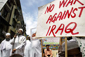 A man speaks during a protest to condemn the US military action in the Iraqi holy city of Najaf, in Mumbai on Friday