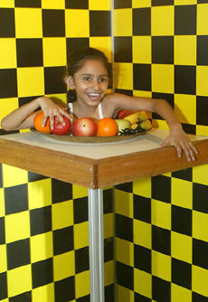 A girl looks at her vanished lower body through an optical illusion