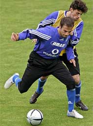 Greek soccer players Demis Nikolaidis (L) and Stelios Venetidis fight for the ball during the team's training session 