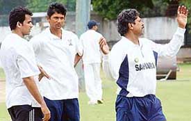 Former Indian captain Kapil Dev giving tips to Zaheer Khan, while former Indian seamer Venkatesh Prasad looks on, at the fitness camp for fast bowlers in Bangalore