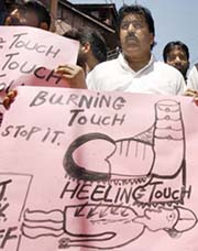 The Vice-Chairman of the Jammu and Kashmir Liberation Front (JKLF) Javid Mir (second from right) holds a banner as he leads a demonstration protesting against alleged human rights violations in Srinagar, on Saturday.