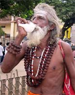 A sadhu blows the conch