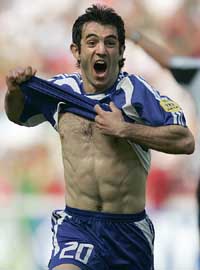 Greece�s Giorgos Karagounis celebrates after scoring the first goal of the Euro 2004 soccer championships opening match against Portugal