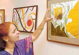 Bharti Sharma shows one of her works on display at Indus Ind Art Gallery in Sector 8, Chandigarh, on Saturday. 