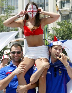 An England woman soccer fan is carried by two French soccer fans