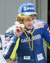 Italian MotoGP rider Valentino Rossi gestures to fans after winning the Catalunya MotoGP race