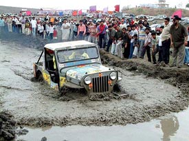 A rallyst driving in 'mud' pond near the dried bank of the Kaliasot dam