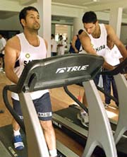 Sachin Tendulkar and Yuvraj Singh walk on treadmills during their fitness camp in Bangalore