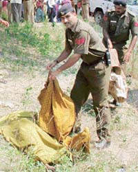 A policeman with the body of a woman, suspected to have been raped before she was murdered