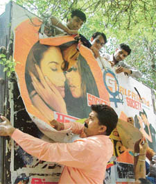 Activists of the All-India Hindu Suraksha Samiti remove posters of �Girlfriend� 