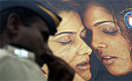 A policeman stands guard in front of a theatre