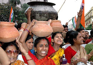 Trinamool Congress activists carry food in utensils in Kolkata