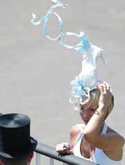 A woman wears an unusual shoe shaped hat