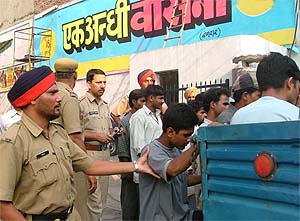 Policemen round up cinegoers as part of the drive to catch suspected robbers in Ludhiana on Wednesday. 