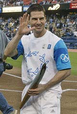 Actor Tom Cruise waves to photographers