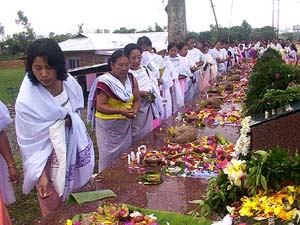People offer floral tributes