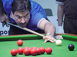 Yasin Merchant of India plays a shot during the Indo-Pak snooker Peace Cup Tournament at Chandigarh Club in Chandigarh on Saturday.