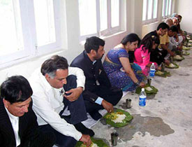 The Union Minister for Steel, Chemicals and Fertilisers, Mr Ram Vilas Paswan, enjoys Himachali food along with his family at Dehar in Sundernagar on Saturday. 