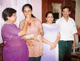 Shina Singla, who has topped the plus two examination of the Punjab Board is greeted by the Principal of the Sanmati Vimal Jain Senior Secondary School, Jagraon