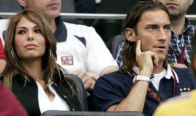 Suspended Italian striker Franceso Totti sits in the stands with his girlfriend Ilary Blasi 